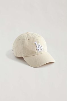 a baseball cap with the los angeles dodgers logo in white on a light grey background