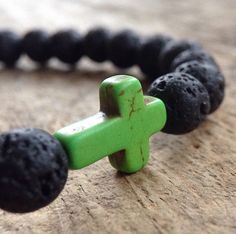 "Add this Christian bracelet to your daily accessories collection. A rustic and symbolic piece perfect for your everyday look. Created with genuine black lava stone beads and a sideways cross. Shown here is a green cross, however, you may choose from a variety of cross colors. See link below for all cross bracelets. {LISTING FEATURES} ~ Exotic bohemian style ~ Sideways cross ~ Textured beads ~ Rustic look ~ Easy to wear ~ High-quality stretch cord that doesn't easily break or lose strength over Mini Rosaries, Lava Rock Bracelet, Daily Accessories, Lava Bead Bracelet, Miss You Gifts, Christian Bracelets, Cross Christian, Distance Gifts, Lava Bracelet