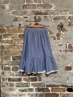 "Cute extra small gathered skirt from the 1980s. Made from light blue chambray denim. Has a ruffle underskirt on Botton edge with wide edging of white broderie anglaise to emulate an underskirt. Waistband with white button closure and centre back zipper. Side seam hidden pockets Waist - 26\"/ 66 cm Waistband width - 1 1/2\" / 4cm Side seam length - waist to hem of white edge  - 25\" / 64cm Outer and inner ruffle width - 9\" /23cm CONDITION -  Excellent -some signs of fraying from age at seams an 1930s Dress, Denim Cotton, Skirt White, Gathered Skirt, The 1980s, Vintage Pattern, White Skirts, Chambray, Denim Skirt