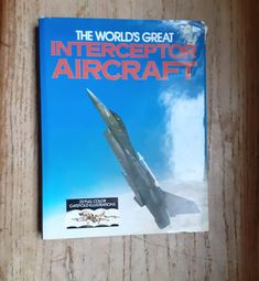 the world's great intercept aircraft book sits on a wooden surface