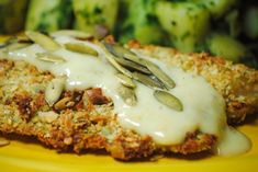 a yellow plate topped with meat covered in gravy