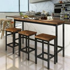 an island in the middle of a kitchen with stools