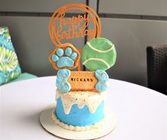 a birthday cake decorated with blue and green icing