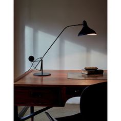 a desk lamp sitting on top of a wooden table