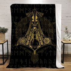 a blanket with an image of the god and goddesss on it, in gold