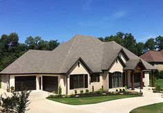 a large house with two car garages in the front yard