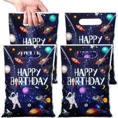 two bags with happy birthday designs on them, one being held up by a hand