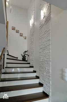 there is a white brick wall on the stairs