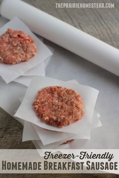 two homemade breakfast sausage patties on parchment paper with a rolling pin in the background