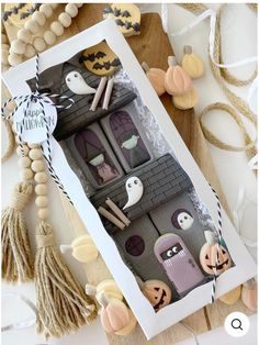 an open box filled with halloween decorations on top of a table