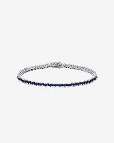 Embrace the refined charm of our Princess Mini Tennis Bracelet. This exquisite piece showcases offset princess-cut sapphires, each one carefully selected to enhance the bracelet's overall elegance. Featuring 3.20 carats of 1.5mm princess-cut dark blue sapphires, it offers versatility for stacking or stands out gracefully as a solo piece. Details 18k white gold 3.20 carats of 1.5mm princess-cut dark blue sapphires Bracelet measures 7 inches in length Box clasp with safety lock fastening 3mm width Classic Sapphire Tennis Bracelet With Brilliant Cut, Timeless Blue Diamond Bracelet, Luxury Sapphire Tennis Bracelet With Brilliant Cut, Classic Sapphire Gemstone Tennis Bracelet, Sapphire Tennis Bracelet With Prong Setting, White Gold Sapphire Tennis Bracelet, White Gold Sapphire Tennis Bracelet For Formal Occasions, Classic Sapphire Bracelet With Prong Setting, Classic Diamond Bracelet With Sapphire