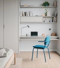 a blue chair sitting in front of a white desk