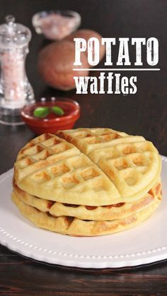 two waffles stacked on top of each other on a white plate with the words potato waffles