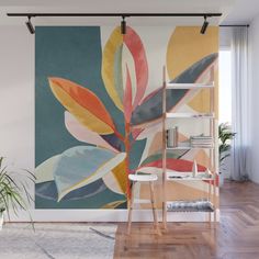 an abstract painting on the wall in a living room with wooden floors and white walls