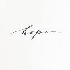 the word hope written in cursive ink on a white paper with black writing