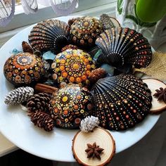 a white plate topped with lots of different types of decorative items on top of a table