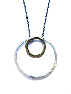 "This mixed metal necklace is a great statement piece and is one of my most popular necklaces. A large hammered sterling circle and small carved brass ring hang from an oxidized, adjustable 16-18\" sterling chain." Cheap Round Metal Chain Necklace, Large Circle Metal Jewelry, Cheap Oxidized Round Pendant Necklace, Affordable Circular Metal Necklaces, Affordable Circular Metal Necklace, Luxury Round Brass Necklace, Mixed Metal Necklace, Popular Necklaces, Burlington Vt