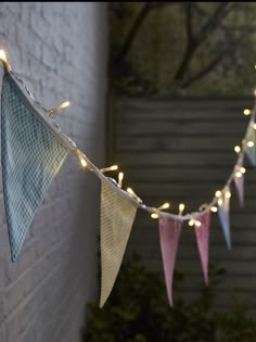 a string of lights hanging from a brick wall