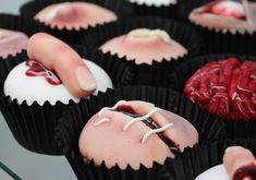 there are many cupcakes that have been decorated with blood and white icing