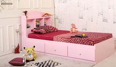 a child's bedroom with pink furniture and accessories on the floor, including a bed