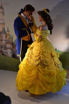 a man and woman dressed as disney characters