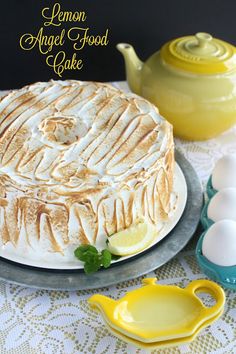 a cake sitting on top of a table next to an egg holder and lemon wedges