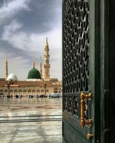 an open door leading to a large building with a green dome on it's side