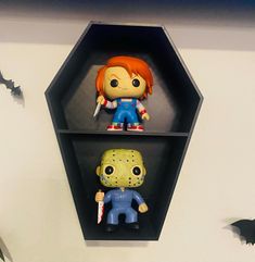 two figurines are sitting on shelves in the shape of hexagons