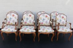 four chairs with floral upholstered back and arms