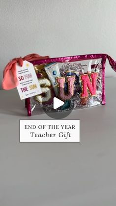 the end of the year teacher gift is in a pink bag with ribbon on it