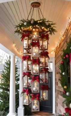 christmas decorations hanging from the side of a house with lights and ornaments on it's front porch