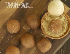 some food is sitting in a small bowl on a wooden board with the words tamarind balls above it