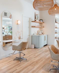 a hair salon with chairs, mirrors and shelves