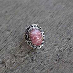 Gemstone - Rhodochrosite Gemstone Size - 12x16 mm oval Metal - Sterling Silver Ring Size - All sizes Available Natural pink rhodochrosite sterling silver handmade ring Rhodochrosite attracts love by opening up the heart chakras with its healing vibrations. It gives us the inner strength to take another chance at love because even if you fall, the Rhodochrosite crystal will always catch you. The ring can be customized on request and gemstone can be switched to any gemstone you want. Feel free to Oval Pink Opal Gemstone Rings, Pink Oval Spiritual Ring, Pink Oval Gemstones For Gift, Pink Oval Gemstones For Gifts, Oval Pink Opal Jewelry For Gifts, Oval Pink Opal Jewelry Gift, Rhodonite Gemstone Jewelry For Gift, Rhodonite Round Natural Stone Jewelry, Round Rhodonite Jewelry With Natural Stones