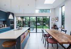 an open kitchen and dining room area with large sliding glass doors leading to the backyard