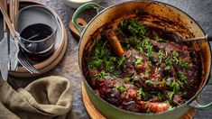 a pot filled with meat and vegetables on top of a table