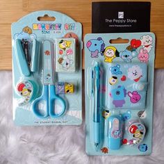 two children's scissors, pen and clipboard set in plastic packaging with bear stickers on them