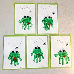 four cards with pictures of green handprints on them, one has eyes and the other has hands