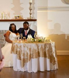 a man and woman sitting at a table with wine glasses