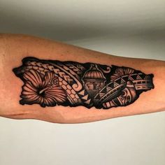 a black and white tattoo design on the arm