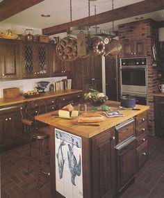 a kitchen with wooden cabinets and an island in front of a stove top oven next to a sink