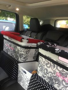 the back seat of a car with several storage bins in it