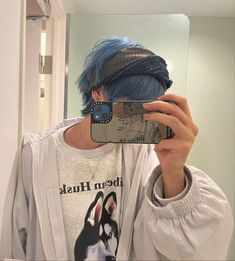 a person with blue hair taking a selfie