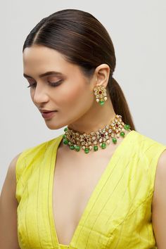 Gold-plated choker with floral motifs, encrusted uncut kundan and emerald bead drops. Comes with ruby studs.
Components:Necklace, Pair of earrings
Type:Kundan, Ruby, Emerald Bead
Composition:Mixed Metal Alloy
Color:Gold
Floral motifs
Bead drops
Size (cm): Necklace: L X B: 17.5 X 4.5; Earrings: 4 X 2.5
Weight (gms): Necklace: 72; Earrings: 16 - Aza Fashions Green Fusion Style Kundan Necklace For Reception, Green Fusion Kundan Necklace For Reception, Designer Green Kundan Necklace With Cutdana, Green Kundan Necklace With Cutdana For Designer Wear, Green Kundan Necklace With Cutdana For Reception, Traditional Green Choker For Reception, Festive Green Cutdana Choker, Floral Choker, Choker Jewellery