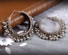 Gungroo adorned Silver Hoop earrings- tinkle your way through the crowd. These beautiful earrings are handcrafted in metal alloy and oxidized silver. It is a perfect match for traditional kurtas and will go with all your casual and formal ethnic attire. Occasion: Will add luster when worn for a wedding, engagement, party, prom and any special occasion. It will enhance special days like Valentine's Day, Birthdays, Anniversaries, and Mother's Day. Ideal Gift Idea: Perfect beautiful & memorable Black Earrings Indian, Trendy Jhumkas, Afghani Earrings, Silver Hoops Earrings, Oxidised Jewelry, Jaipur Jewelry, Pakistani Earrings, Color Knowledge, Oxidized Earrings