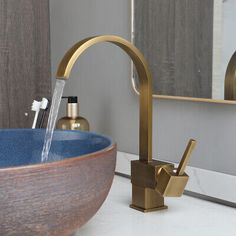 a bathroom sink that has a faucet and soap dispenser in it