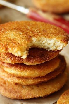 a stack of fried food on top of a table next to a fork and spoon