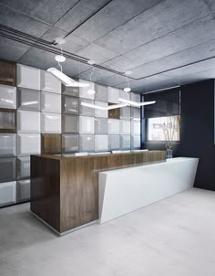 an empty office with white and wood accents