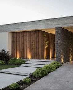 a modern house with stone steps leading up to it