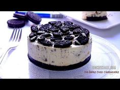 an oreo cookies and cream cake on a plate with silverware next to it